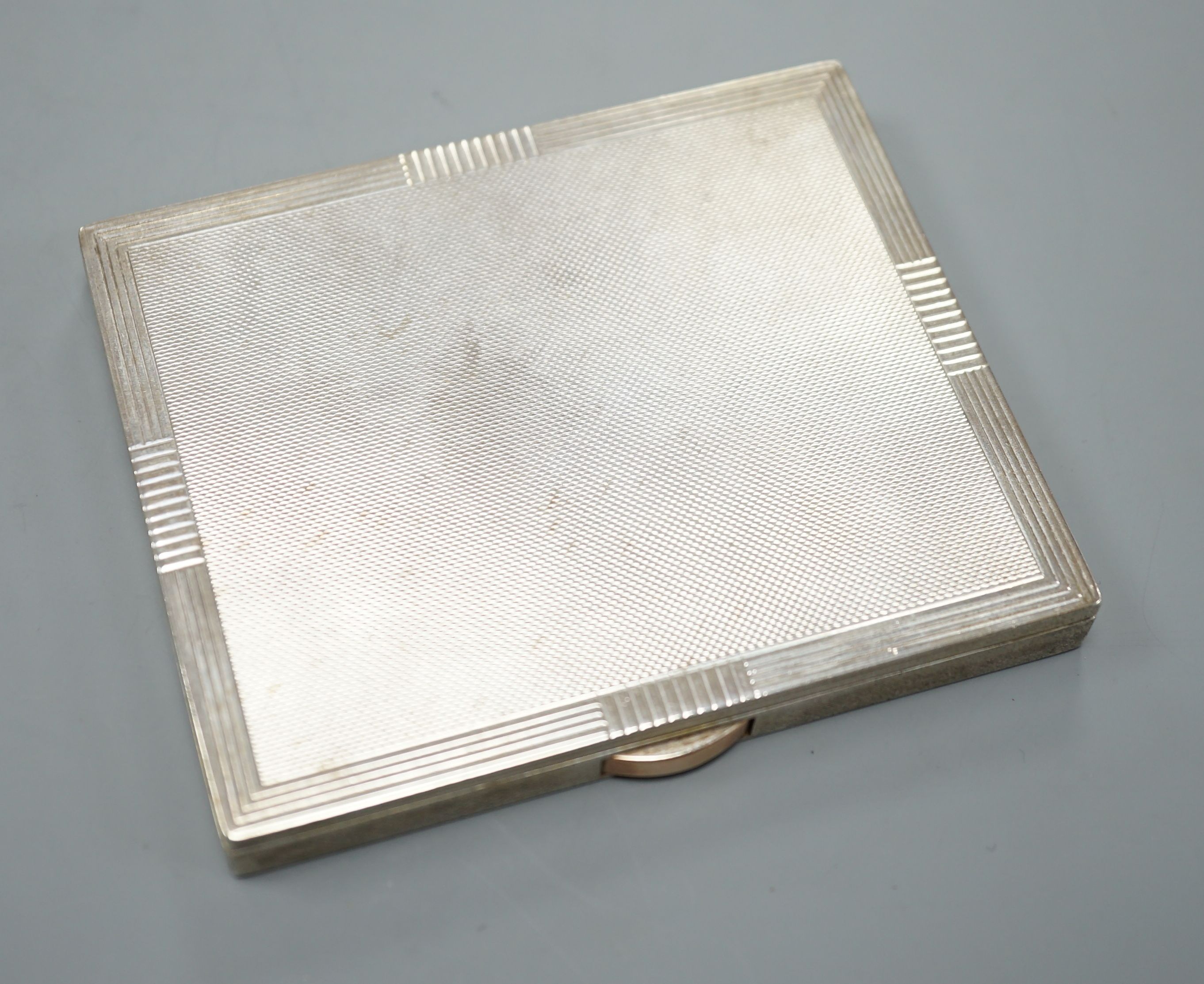 A George VI engine turned silver cigarette case, Birmingham, 1951, 96mm.